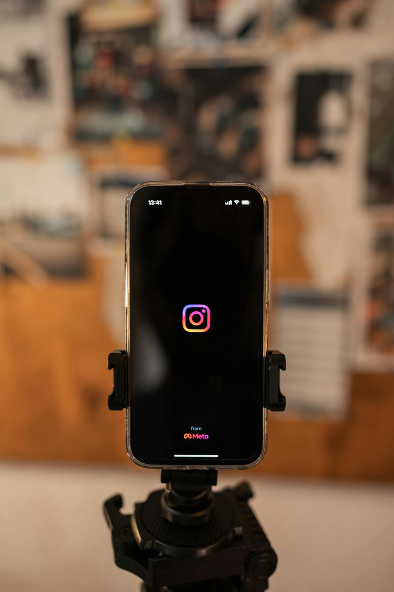 Smartphone displaying Instagram logo on tripod, perfect for social media concepts.